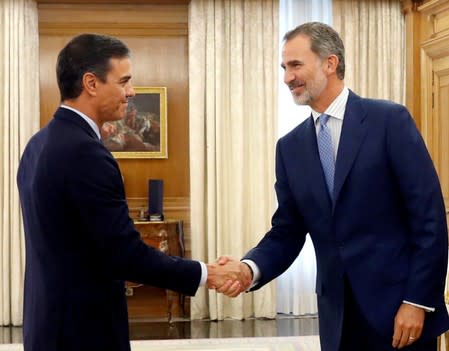 Spain's King Felipe greets acting Prime Minister Pedro Sanchez before their meeting in Madrid