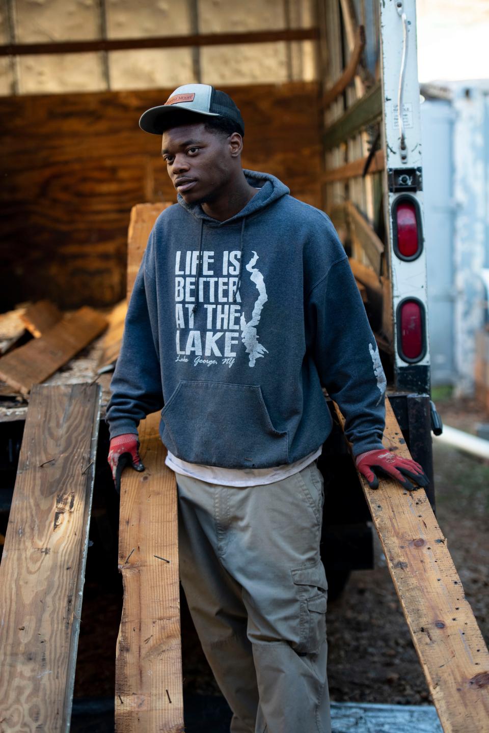 Christopher Wallace, 27, new to Soteria, works to remove nails from reclaimed wood at the wood shop on Wednesday, Dec. 13, 2023. Soteria Community Development Corporation's wood shop is a part of the Soteria at Work program, providing people the opportunity to learn new skills.
