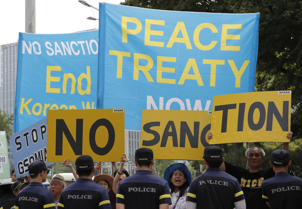 South Korean protesters hold signs during a rally to demand the peace on the Korean peninsula and to stop sanctions against North Korea in front of Foreign Ministry before U.S. Special Representative for North Korea Stephen Biegun's arrival to meet his South Korean counterpart Lee Do-hoon, in Seoul, South Korea, Wednesday, Aug. 21, 2019. The top U.S. envoy on North Korea said Washington is ready to restart nuclear negotiations with North Korea. (AP Photo/Lee Jin-man)