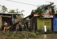 <p>In this Saturday, Sept. 15, 2018, file photo, a resident cleans up pieces from a tree that was toppled by strong winds from Typhoon Mangkhut as it barreled across Tuguegarao city in Cagayan province, the northeastern Philippines.<br>(Photo by Aaron Favila, AP) </p>