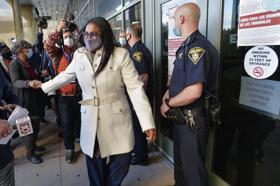 Rochester Mayor Lovely Warren, center, is greeted by supporters after her arraignment in city court in Rochester, N.Y., Monday, Oct. 5, 2020. Warren, who has faced calls to resign over her city's handling of the suffocation death of Daniel Prude at the hands of police, pleaded not guilty Monday to campaign finance charges dating to her 2017 reelection campaign. (AP Photo/Adrian Kraus)