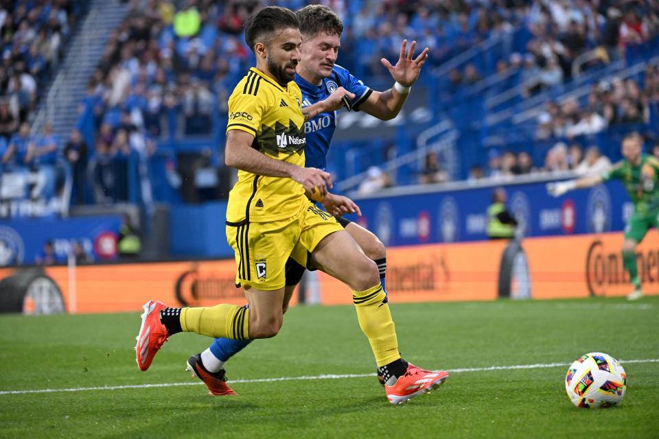 May 15, 2024; Montreal, Quebec, CAN; Columbus Crew forward Diego Rossi (10) dribbles against CF Montreal defender Joaquin Sosa (3) during the first half at Stade Saputo. Mandatory Credit: David Kirouac-USA TODAY Sports