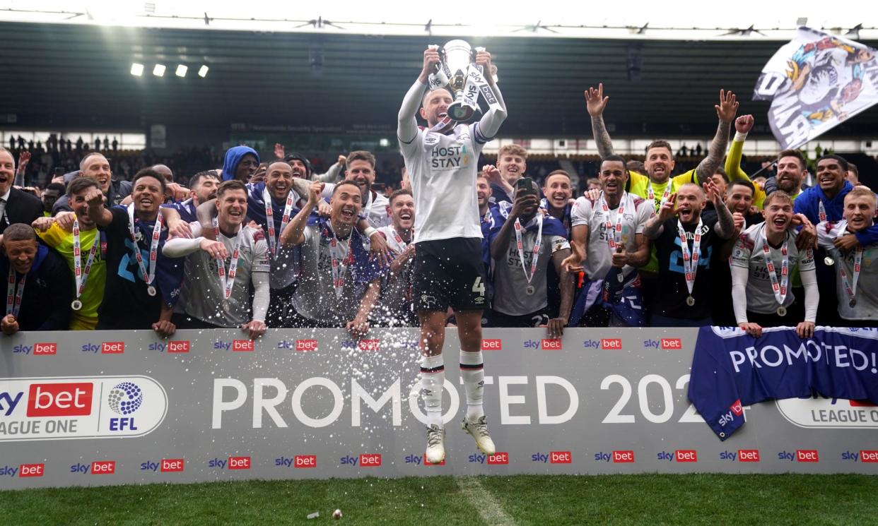 <span>Derby's Conor Hourihane lifts the League One runners-up trophy.</span><span>Photograph: Joe Giddens/PA</span>