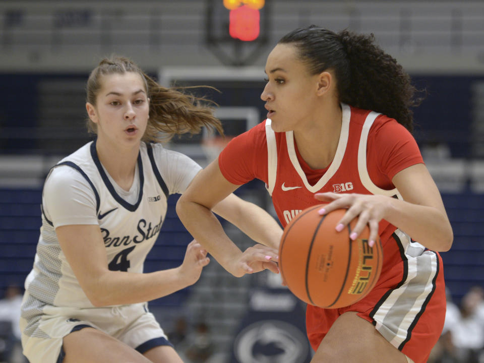 Ohio State's Celeste Taylor, right, drives to the basket against Penn State's Shay Ciezki (4) during the first half of an NCAA college basketball game Thursday, Feb. 22, 2024, in State College, Pa. (AP Photo/Gary M. Baranec)