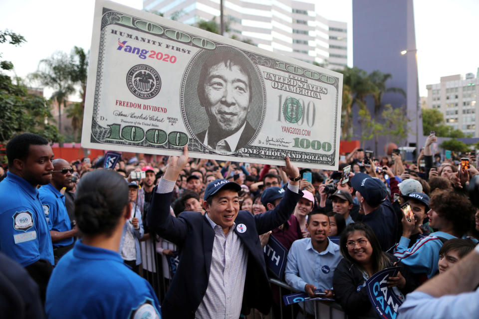 U.S. Democratic presidential candidate Andrew Yang hoists a supporter's sign after speaking at a rally in downtown Los Angeles, California, U.S., April 22, 2019. REUTERS/Lucy Nicholson     TPX IMAGES OF THE DAY