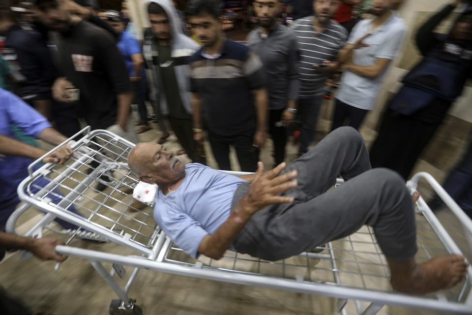 A wounded Palestinian man is wheeled into the Nasser Medical Complex, following Israeli airstrikes on town of Khan Younis, southern Gaza Strip, Monday, Oct. 23, 2023. (AP Photo/Mohammed Dahman)