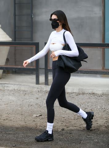 kendall jenner wears a white top, black leggings and nike sneakers while  stepping out for lunch in los angeles-160622_13