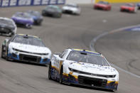 AJ Allmendinger (16) leads a line of cars as Stage 2 begins during a NASCAR Cup Series auto race on Sunday, March 5, 2023, in Las Vegas. (AP Photo/Ellen Schmidt)