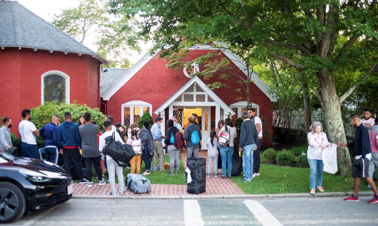 <span>Venezuelan migrants stand outside St Andrew's Church in Edgartown, Massachusetts, on 14 September 2022.</span><span>Photograph: Ray Ewing/Vineyard Gazette/Reuters</span>