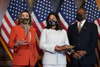 House Speaker Nancy Pelosi of Calif., left, speaks during a ceremonial swearing-in for Rep. Troy Carter, D-La., right, as his wife Ana Carter, center, watches on Capitol Hill in Washington, Tuesday, May 11, 2021. (AP Photo/Susan Walsh)