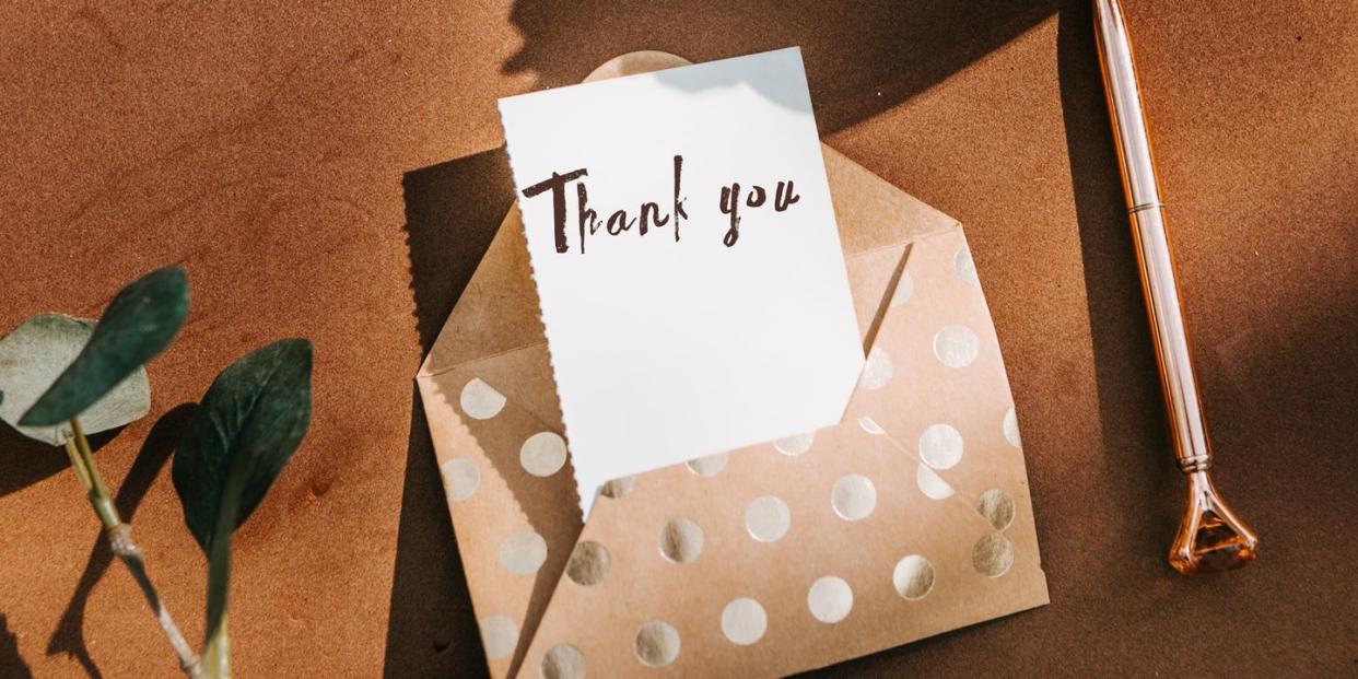 thank you note in gold polka dot envelope with gold pen