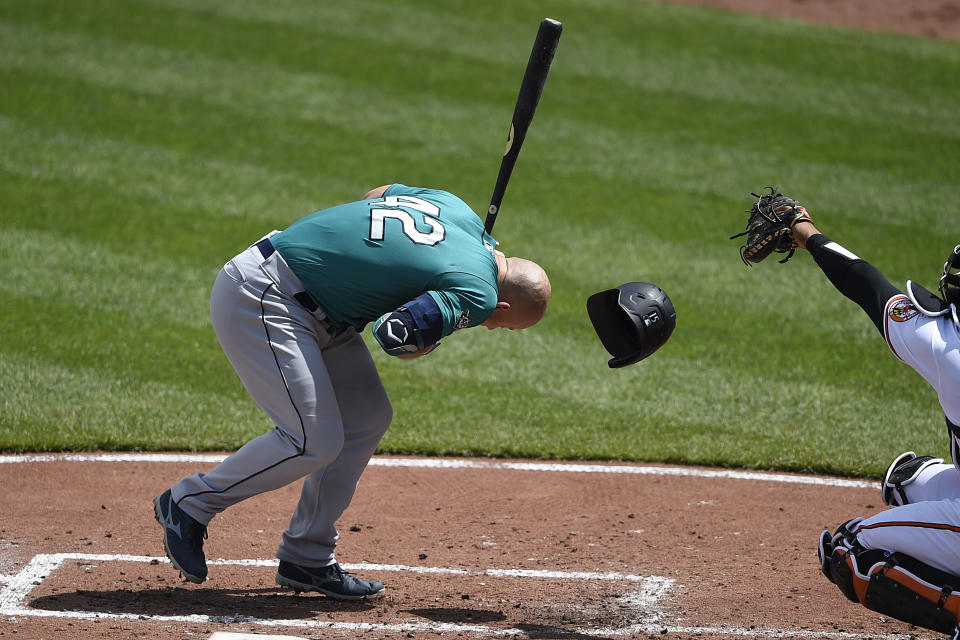 Seattle Mariners' Kyle Seager is hit by a pitch knocking his helmet off in the fourth inning of the first game of a baseball doubleheader against the Baltimore Orioles, Thursday, April 15, 2021, in Baltimore. (AP Photo/Gail Burton)