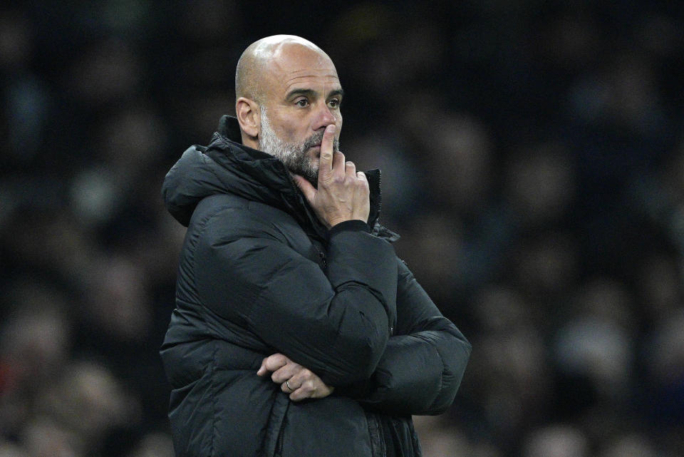 Manchester City's head coach Pep Guardiola pauses as he stands on the touchline during the English FA Cup fourth round soccer match between Tottenham Hotspur and Manchester City in London, Friday, Jan. 26, 2024. (AP Photo/Dave Shopland)