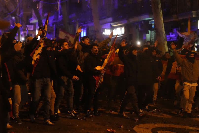 Protesters confront the police during a protest by right wing demonstrators near the national headquarters of Spain's Socialist Party in Madrid, Spain, Tuesday, Nov. 7, 2023.