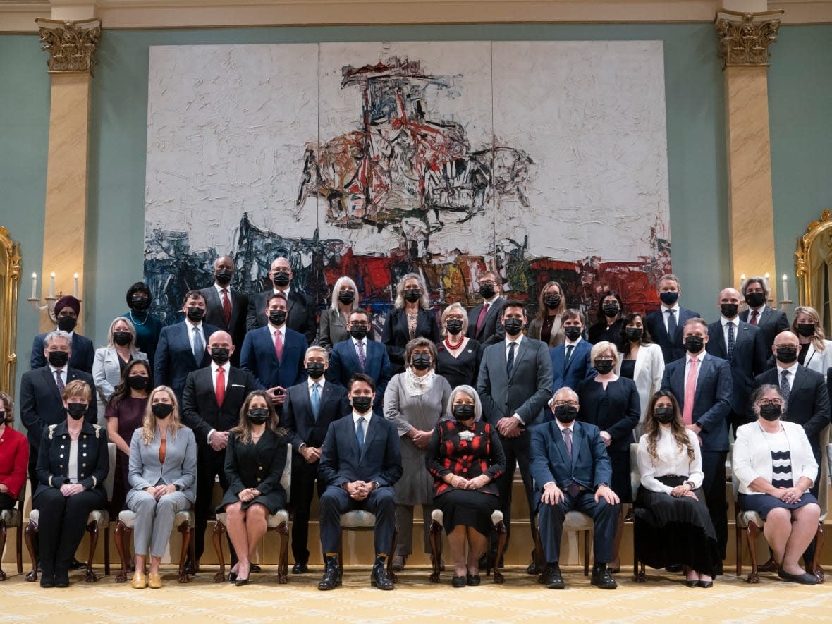 Gov. Gen. Mary May Simon sits with Canadian Prime Minister Justin Trudeau and members of the newly announced cabinet following a swearing-in ceremony at Rideau Hall, Tuesday, Oct. 26, 2021 in Ottawa.   (Adrian Wyld/The Canadian Press - image credit)