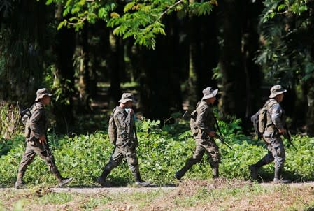 Soldiers patrol during a temporary state of siege, approved by the Guatemalan Congress following the death of several soldiers last week, in the community of Semuy II, Izabal province