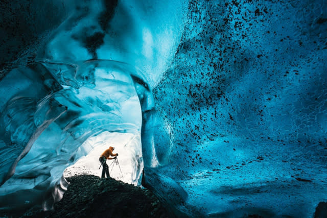 Wednesday 25th November 2015, Vatnajï¿½kull national park, Iceland: Photographer Mikael Buck with assistance from renowned local Icelandic guide Einar Runar Sigurdsson, explored the frozen world of Vatnajï¿½kull glacier in Iceland using Sonyï¿½s world first back-illuminated full-frame sensor ï¿½ which features in the ?7R II camera. His images were taken without use of a tripod or any image stitching techniques in photoshop. This was made possible through Sonyï¿½s new sensor technology, allowing incredibly detailed low-light hand held photography. Previously images this detailed would have required carrying bulky equipment to the caves, some of which can require hiking and climbing over a glacier for up to two hours to to access.This picture: Inside the 'ABC cave' - which stands for Amazing Blue Cave.  Guide Einar Runar Sigurdsson is seen taking a photo at the entrance to the cavePR Handout - editorial usage only. Photographer's details not to be removed from metadata or byline.For further information please contact Rochelle Collison at Hope & Glory PR on 020 7014 5306 or rochelle.collison@hopeandglorypr.comCopyright: ï¿½ Mikael Buck / Sony07828 201 042 / mikaelbuck@gmail.com