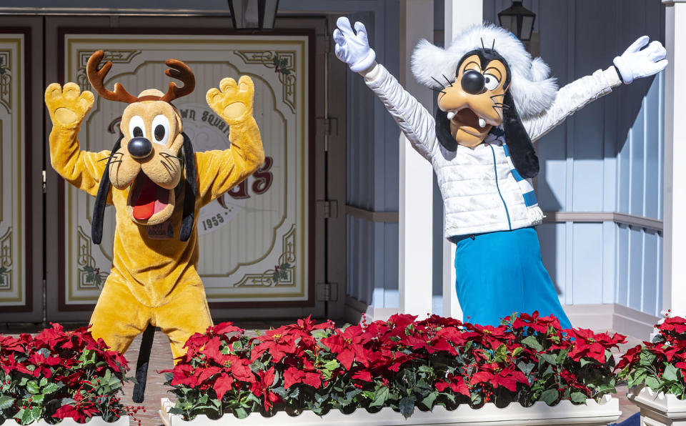 Cast members dressed as Pluto and Goofy at Disneyland, in Anaheim, Calif. (Mark Rightmire / MediaNews Group via Getty Images file )