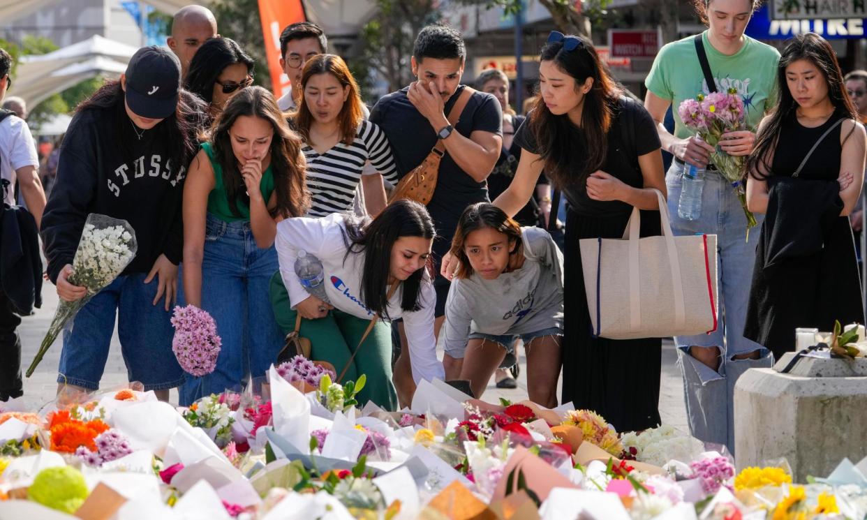 <span>Members of the public add flowers to the expanding mass near the crime scene at Bondi Junction in Sydney, where six people were stabbed to death at Westfield Shopping Centre.</span><span>Photograph: Mark Baker/AP</span>