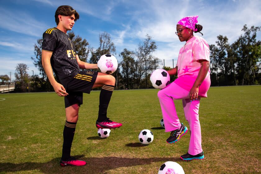 Artist Alake Shilling and Christopher Jaime, a midfielder with LAFC2 play soccer.