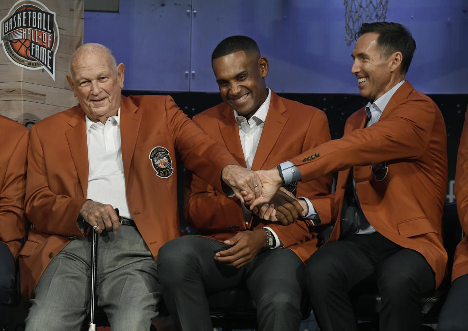 Class of 2018 inductees into the Basketball Hall of Fame, from right, Steve Nash, Grant Hill, and Charles "Lefty" Driesell grasp hands during a news conference at the Naismith Memorial Basketball Hall of Fame, Thursday, Sept. 6, 2018, in Springfield, Mass. (AP Photo/Jessica Hill)