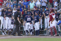 Mississippi infielder Tim Elko (25) celebrates his home run with teammates in the third inning during the first championship baseball game of the NCAA College World Series against Oklahoma, Saturday, June 25, 2022, in Omaha, Neb. (AP Photo/John Peterson)