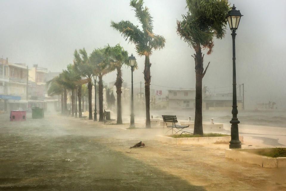 Seawater from crashing waves cover a road at the port of Argostoli, on the Ionian island of Kefalonia, western Greece, Friday, Sept. 18, 2020. Hurricane-force winds and heavy rainfall battered several islands off the western coast of Greece Friday, causing power outages and road closures, as authorities in nearby mainland areas remained on alert. (AP Photo/Nikiforos Stamenis)