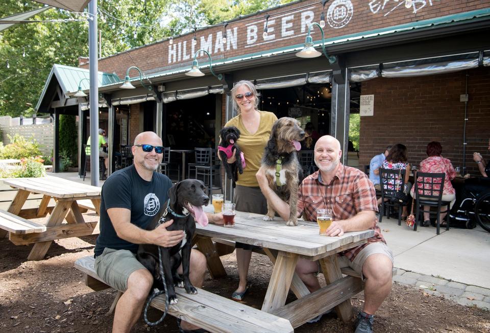 Owners of Hillman Beer Brad, left, Brandi, center, and Greig Hillman pose with their dogs Roland, Tulip and Hazel at the brewery on Aug. 16, 2019.