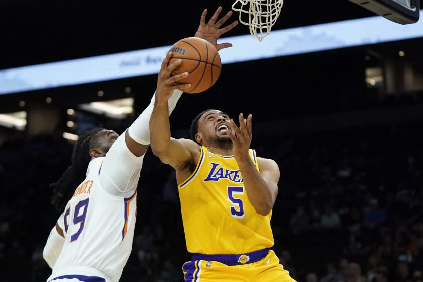 Los Angeles Lakers guard Talen Horton-Tucker (5) is fouled by Phoenix Suns forward Jae Crowder, left, during the first half of a preseason NBA basketball game Wednesday, Oct. 6, 2021, in Phoenix. (AP Photo/Ross D. Franklin)