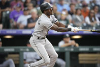 Chicago White Sox's Tim Anderson follows the flight of his double off Colorado Rockies starting pitcher German Marquez in the third inning of a baseball game Tuesday, July 26, 2022, in Denver. (AP Photo/David Zalubowski)