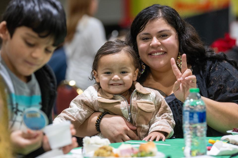 Denise Soto and her 2-year-old son, Eziel, pose for a photo Monday at the annual Christmas Family Feast on Monday at the Wisconsin Center in Milwaukee. The Salvation Army expected to serve a Christmas dinner to about 4,000 people.