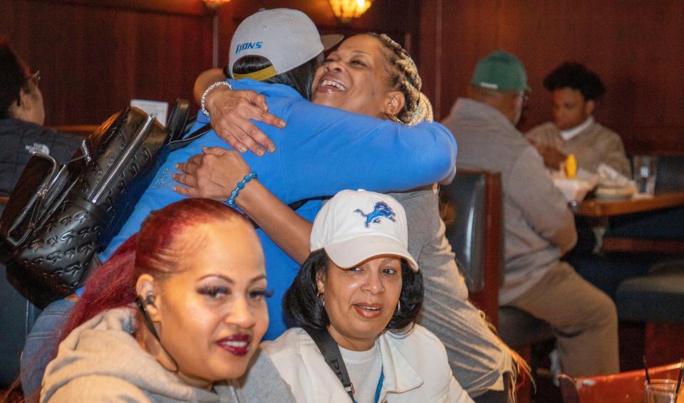 Rita Foster, center, hugs Rochelle Nicholson as she meets her friends at the beginning of day 2 of the NFL Draft on April 29, 2022, that brought 10 proud members of the Detroit Lions Tailgating Divas to Mr. Joe's Bar and Grill in Southfield. Before the Lions selected Kentucky defensive end Josh Paschal with the team's first pick of Day 2, the Divas celebrated their longtime friendships and even accepted a friendly challenge from another fan to sing the Lions fight song. 