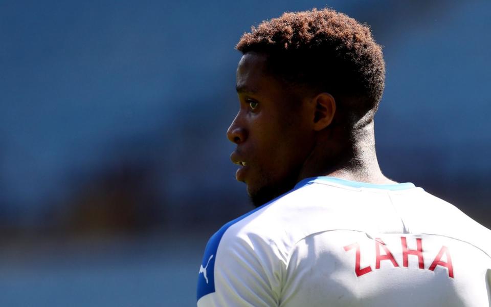 Crystal Palace's Ivorian striker Wilfried Zaha looks on during the English Premier League football match between Aston Villa and Crystal Palace at Villa Park in Birmingham, central England on July 12, 2020. - GETTY IMAGES