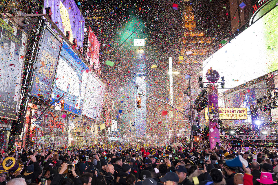 FILE - In this Jan. 1, 2020, file photo, confetti falls at midnight on the Times Square New Year's Eve celebration in New York. If ever a year's end seemed like cause for celebration, 2020 might be it. Yet the coronavirus scourge that dominated the year is also looming over New Year's festivities and forcing officials worldwide to tone them down. (Photo by Ben Hider/Invision/AP, File)