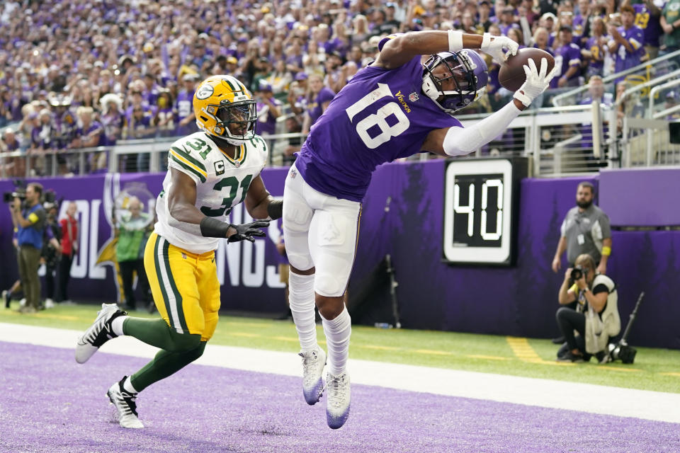 Minnesota Vikings wide receiver Justin Jefferson (18) tries to catch a pass in the end zone ahead of Green Bay Packers safety Adrian Amos (31) during the first half of an NFL football game, Sunday, Sept. 11, 2022, in Minneapolis. The pass was incomplete. (AP Photo/Abbie Parr)