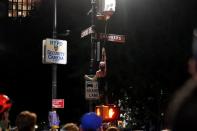 A protester disables a police camera during a protest to defund the police in a place they are calling the "City Hall Autonomous Zone" in support of "Black Lives Matter" in the Manhattan borough of New York City