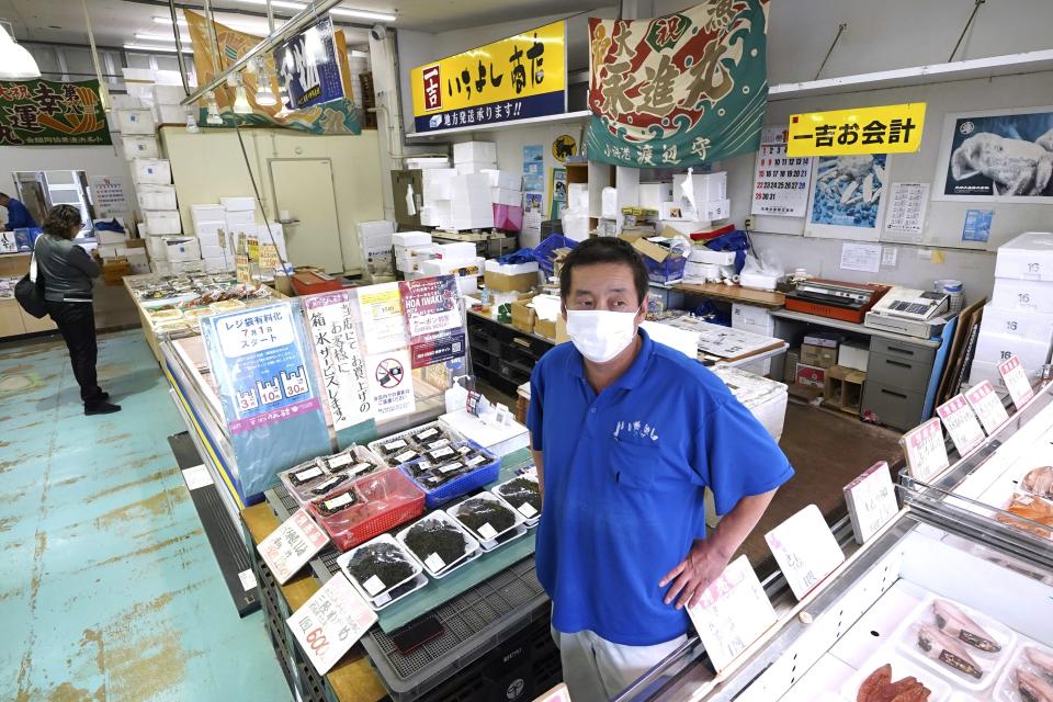 Ichiyoshi fish store manager Hiroharu Haga speaks during an interview with The Associated Press at the seafood market "Lalamew" near the Onahama fish port in Iwaki City, Fukushima Prefecture, on Oct. 19, 2023 in Iwaki, northeastern Japan. Haga said that although customers increased after the treated water discharge, with many ordering from outside of Fukushima, he cannot meet all the requests because of a limited supply. Fukushima’s local catch today is still about one-fifth of its pre-disaster levels due to a decline in the fishing population and smaller catch sizes. (AP Photo/Eugene Hoshiko)
