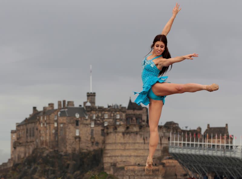 FILE PHOTO: Dancer Lombardi from Rock the Ballet performs with Edinburgh Castle in the background during a photocall for their shows at the Fringe Festival in Edinburgh, Scotland