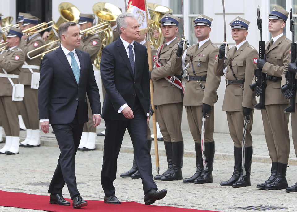 CAPTION CORRECTS THE NAME - Polish President Andrzej Duda, left, and Lithuanian President Gitanas Nauseda, right, attend a military welcome ceremony at the presidential Palace in Warsaw, Poland, Tuesday, July 16, 2019.(AP Photo/Czarek Sokolowski)