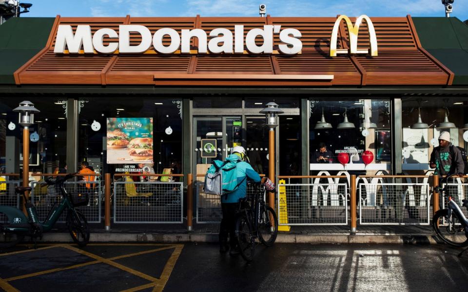 A Deliveroo rider outside a McDonald's restaurant in London, 2021