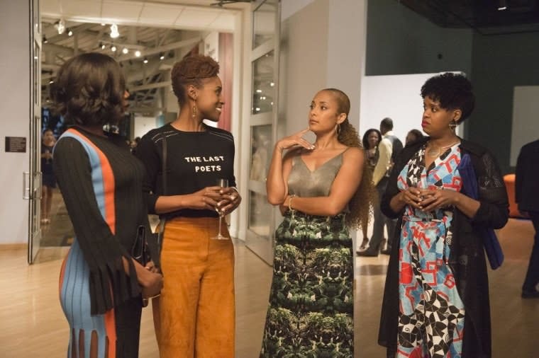 Molly, Issa, Tiffany, and Kelly standing and talking at an event