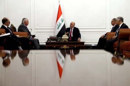 U.S. Secretary of State Rex Tillerson (2-L) listens as Iraqi Prime Minister Haider al-Abadi (C) speaks during their meeting in Baghdad, Iraq October 23, 2017. REUTERS/Alex Brandon/Pool