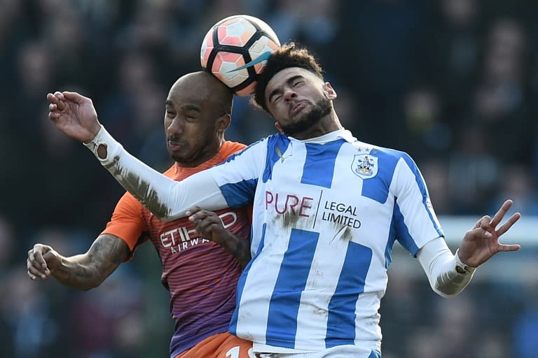 Huddersfield Town's Philip Billing (R) vies with Manchester City's Fabian Delph during their English FA Cup fifth round match on February 18, 2017