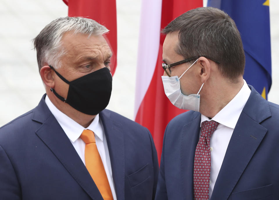 Poland's Prime Minister Mateusz Morawiecki, right, is greeting his counterpart from Hungary, Viktor Orban, left, at the start of the Visegrad Group premiers' meeting in Lublin, Poland, Friday, Sept. 11, 2020. In preparation for European Union summit this month, the meeting is to discuss situation in Belarus, ties with Russia and fighting COVID-19. (AP Photo/Czarek Sokolowski)