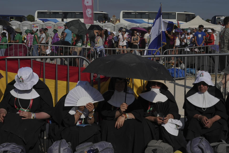 Nuns gather at Parque Tejo in Lisbon where Pope Francis is presiding over a mass celebrating the 37th World Youth Day, Sunday, Aug. 6, 2023. An estimated 1.5 million young people filled the parque on Saturday for Pope Francis' World Youth Day vigil, braving scorching heat to secure a spot for the evening prayer and to camp out overnight for his final farewell Mass on Sunday morning. (AP Photo/Ana Brigida)