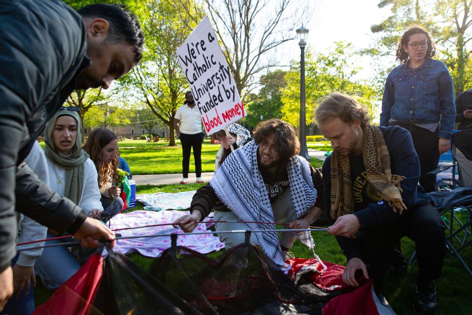 Students and community members build tents that were later torn down by Notre Dame Police during a pro-Palestinian protest on the University of Notre Dame's campus on Thursday, April 25, 2024.