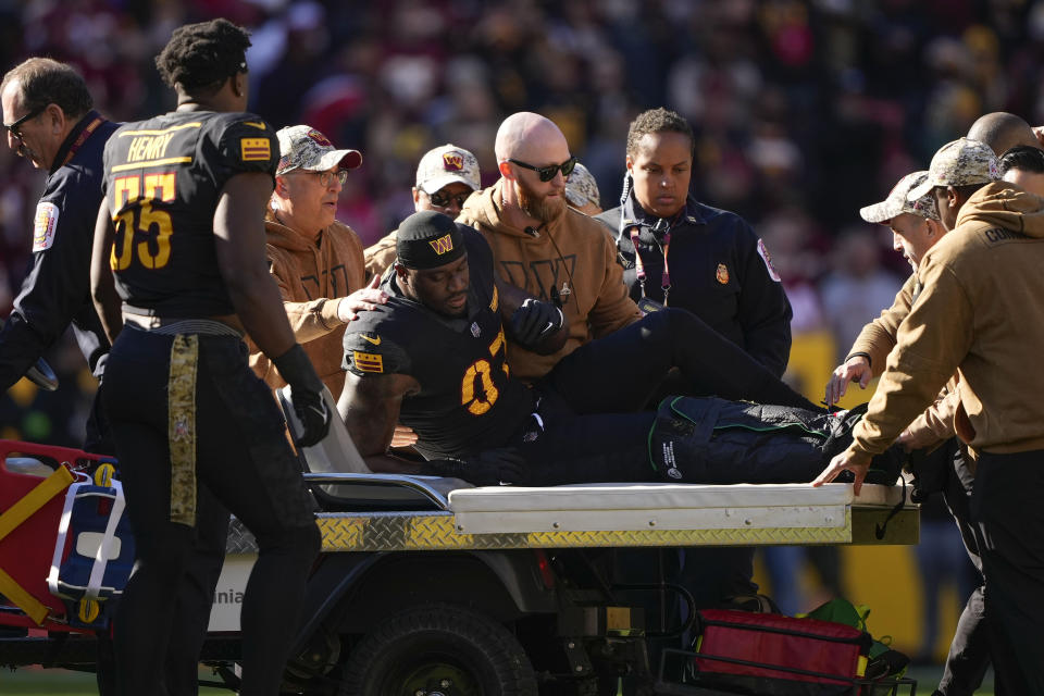 Washington Commanders defensive end Efe Obada (97) is placed on a cart after sustaining an injury during the first half of an NFL football game against the New York Giants, Sunday, Nov. 19, 2023, in Landover, Md.(AP Photo/Andrew Harnik)