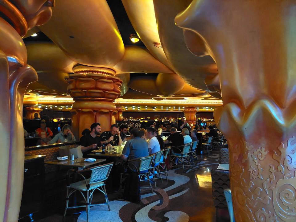 The interior of the Cheesecake Factory in Chicago on the Magnificent Mile. The photo shows tables of diners