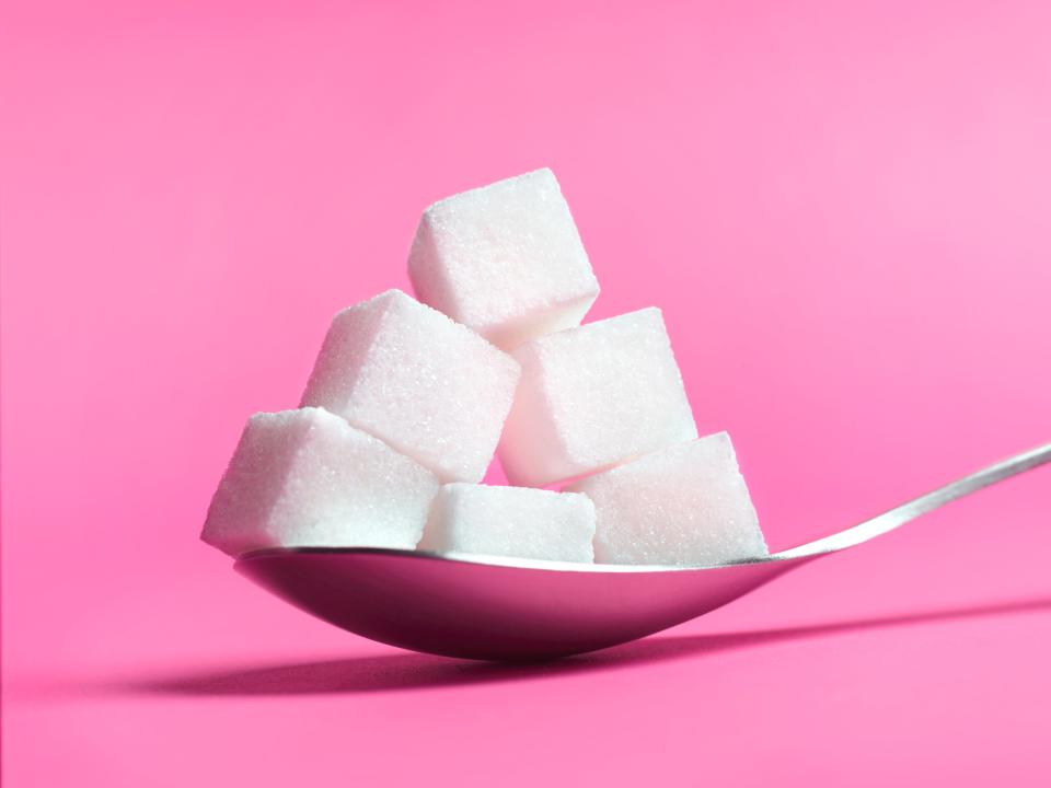 Spoon filled with sugar cubes