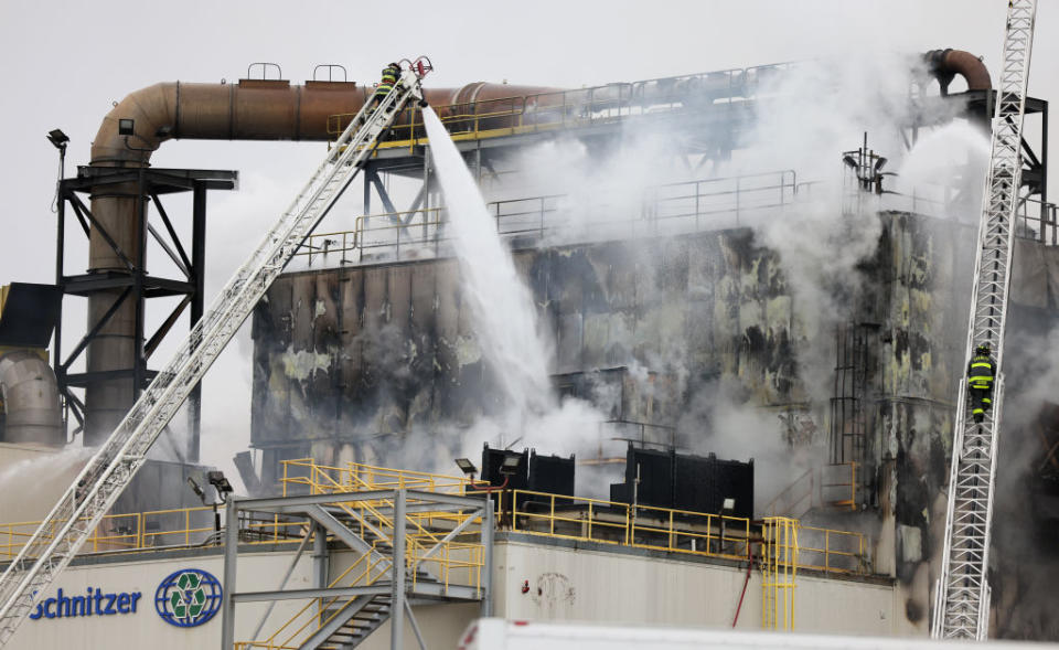 Firefighters work on a four-alarm fire at a metals recycling yard in Everett, Mass., on Dec. 8, 2021.<span class="copyright">Jessica Rinaldi—The Boston Globe/Getty Images</span>